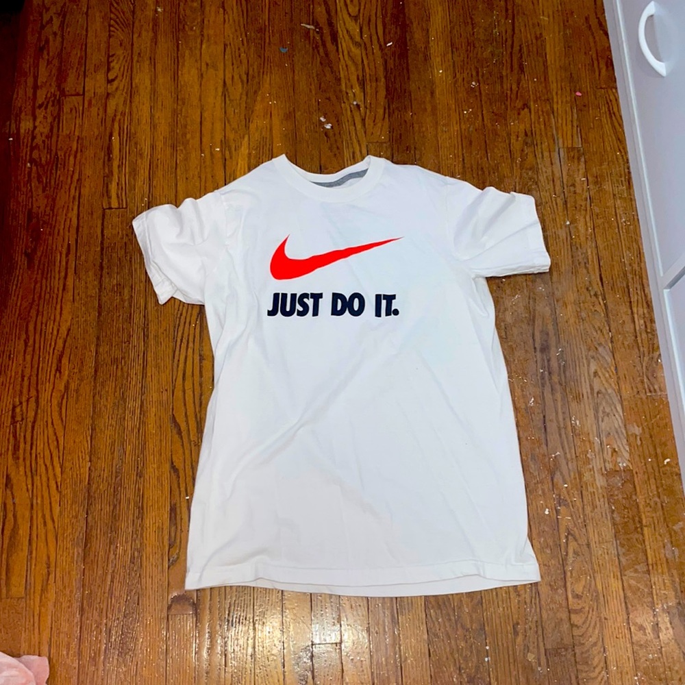 The brand is Nike and it has an orange Nike sign it has the letters just do it.